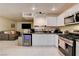 Open kitchen featuring white cabinetry and stainless steel appliances at 3322 Dragon Fly St, North Las Vegas, NV 89032