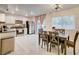 Open kitchen and dining space with stainless steel appliances, white cabinets, and dining table set for six at 3322 Dragon Fly St, North Las Vegas, NV 89032
