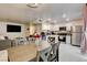 Open-concept kitchen and dining area with white cabinets, stainless steel appliances, and modern lighting at 3322 Dragon Fly St, North Las Vegas, NV 89032