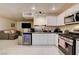 Open-concept kitchen with sleek appliances, ample counter space, and a view into the cozy living area at 3322 Dragon Fly St, North Las Vegas, NV 89032