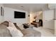 Comfortable living room with a plush gray sectional sofa, flat screen TV, and white tile flooring at 3322 Dragon Fly St, North Las Vegas, NV 89032