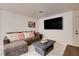 Inviting living room features a gray sectional sofa, decorative pillows, and a stylish coffee table at 3322 Dragon Fly St, North Las Vegas, NV 89032