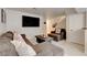 Inviting living room featuring a comfortable sectional sofa and a large flat-screen television for entertainment at 3322 Dragon Fly St, North Las Vegas, NV 89032