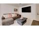 Cozy living room showcasing a stylish sectional sofa with pink pillows and a modern coffee table at 3322 Dragon Fly St, North Las Vegas, NV 89032