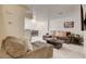 Comfortable living room with sectional sofa and view into dining area at 3322 Dragon Fly St, North Las Vegas, NV 89032