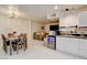 Open-concept living space with kitchen, dining area, and comfortable seating at 3322 Dragon Fly St, North Las Vegas, NV 89032