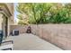 This patio is surrounded by a brick wall and foliage at 3322 Dragon Fly St, North Las Vegas, NV 89032
