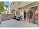 This patio has comfortable seating and glass doors to the home's interior at 3322 Dragon Fly St, North Las Vegas, NV 89032