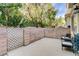 This patio is surrounded by a brick wall and has a lattice gate at 3322 Dragon Fly St, North Las Vegas, NV 89032