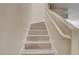 A view of a light colored wooden staircase with white risers and handrail at 3322 Dragon Fly St, North Las Vegas, NV 89032