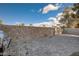 Large stone-walled backyard with brick patio and grill at 3412 Adventure Ct, Las Vegas, NV 89129