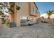 Exterior of home with brick-paved backyard including BBQ, exercise equipment and privacy wall at 3412 Adventure Ct, Las Vegas, NV 89129