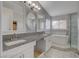 Bright bathroom featuring double sinks, granite countertops, large mirror, soaking tub, and walk-in shower at 3412 Adventure Ct, Las Vegas, NV 89129