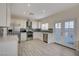 Modern kitchen featuring white cabinetry, stainless steel appliances, and stylish backsplash with access to backyard at 3412 Adventure Ct, Las Vegas, NV 89129