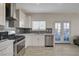 Contemporary kitchen with white cabinets, stainless steel appliances, and modern fixtures for a sleek design at 3412 Adventure Ct, Las Vegas, NV 89129