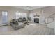 Bright living room with a decorative fireplace, a gray leather sectional, and large windows for natural light at 3412 Adventure Ct, Las Vegas, NV 89129