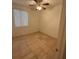 A bedroom with a ceiling fan and tile floors with a bright window at 3416 Mountain Park St, Las Vegas, NV 89129
