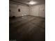 Interior of garage featuring concrete floor, roll-up door, and ample lighting at 3416 Mountain Park St, Las Vegas, NV 89129