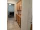 Hallway featuring wooden cabinets and ample storage space, enhancing the practicality of the home at 3416 Mountain Park St, Las Vegas, NV 89129