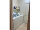 Laundry room with washer, dryer, and shelving, leading to exterior door at 3416 Mountain Park St, Las Vegas, NV 89129