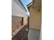 Narrow side yard between two properties with rock cover and block wall for privacy at 3416 Mountain Park St, Las Vegas, NV 89129
