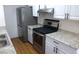 Bright kitchen featuring stainless steel appliances, stone countertops, and white cabinets at 3441 Villa Way, Las Vegas, NV 89120