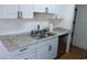 Kitchen sink and stainless steel dishwasher, complemented by white cabinetry at 3441 Villa Way, Las Vegas, NV 89120