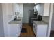 This is a kitchen with white cabinets, black hardware, granite counters, and stainless steel appliances at 3441 Villa Way, Las Vegas, NV 89120