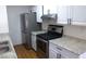 Bright kitchen featuring stainless steel appliances, stone countertops, and white cabinets at 3441 Villa Way, Las Vegas, NV 89120