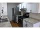 Well-lit kitchen features stainless steel appliances, stone countertops, and white cabinets at 3441 Villa Way, Las Vegas, NV 89120