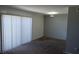 This living room features carpet, a wall with gray paint, white blinds and a sliding glass door to the exterior at 3441 Villa Way, Las Vegas, NV 89120