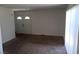 This is a living room featuring neutral carpet, white walls, a double door, and a window with blinds at 3441 Villa Way, Las Vegas, NV 89120