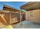 Enclosed patio with a wooden fence and partial roof, with a door that provides access to the house at 3441 Villa Way, Las Vegas, NV 89120
