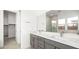Bathroom with double sink vanity, large mirror, and view of the shower at 362 Tigullio Ave, Henderson, NV 89011