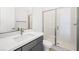 Modern bathroom features a walk-in shower and vanity with gray cabinets at 362 Tigullio Ave, Henderson, NV 89011