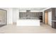 Bright, modern kitchen with a white island, stainless appliances, and neutral cabinets at 362 Tigullio Ave, Henderson, NV 89011