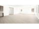 Open concept living area with neutral tile flooring and seamlessly connected kitchen and dining spaces at 362 Tigullio Ave, Henderson, NV 89011