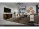 Cozy living room with a plush sofa, stylish coffee table, and a large TV for entertainment at 390 Arizona St # Lot 9, Boulder City, NV 89005
