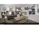 Open-concept living room with comfortable seating, stylish decor, and seamless flow to kitchen at 390 Arizona St # Lot 9, Boulder City, NV 89005