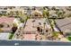 Picturesque aerial view of a single-Gathering home showcasing the roof, three-car garage, and drought-resistant landscaping at 4624 Leon De Oro Dr, Las Vegas, NV 89129