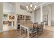 Open dining room with hardwood floors, built-in cabinets, and views of the kitchen area at 4624 Leon De Oro Dr, Las Vegas, NV 89129