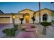 Charming home exterior with manicured front yard, mature palm trees, and a three-car garage at 4624 Leon De Oro Dr, Las Vegas, NV 89129