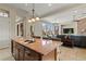 Kitchen island features granite countertops, sink, and seating, connecting seamlessly to the living area at 4624 Leon De Oro Dr, Las Vegas, NV 89129