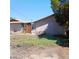 Exterior shows a tan siding home with overgrown backyard needing some TLC and maintenance at 4931 Nevada Ave, Las Vegas, NV 89104