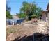 Backyard featuring a damaged above-ground pool and mature trees at 4931 Nevada Ave, Las Vegas, NV 89104