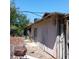 Shabby exterior with weathered siding and vintage air conditioning unit at 4931 Nevada Ave, Las Vegas, NV 89104