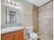 Bathroom featuring a granite countertop vanity and tiled shower, offering modern comfort at 520 Prince Alan Ct, Las Vegas, NV 89110