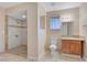 Bathroom with a granite vanity, toilet, and a shower with decorative tile at 520 Prince Alan Ct, Las Vegas, NV 89110