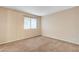 Cozy carpeted bedroom featuring window and neutral walls at 520 Prince Alan Ct, Las Vegas, NV 89110