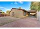 Home exterior with gravel yard, carport and brick patio, perfect for enjoying outdoor activities at 520 Prince Alan Ct, Las Vegas, NV 89110
